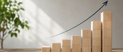 Composizione minimalista di blocchi in legno illuminati da luce naturale, simbolo della crescita, dell'integrazione e dello sviluppo del gruppo Abbrevia.